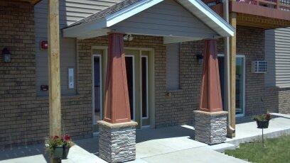 waupun mayfair apartments entry with grass - Live Like a King